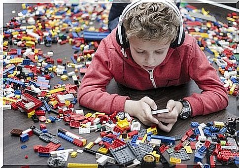 Child talking on cellphone in the midst of toys