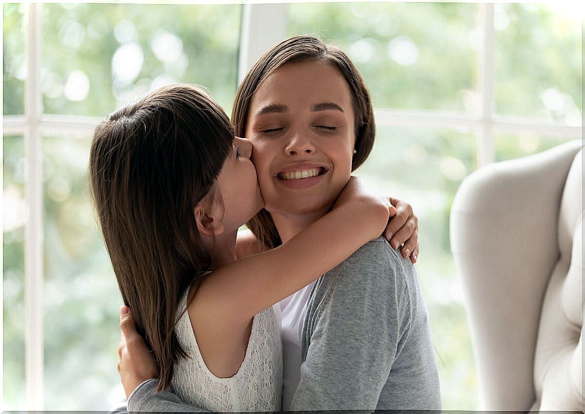 Little girl kissing her mother