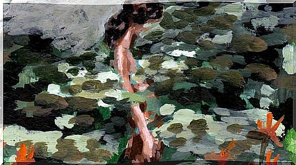 A woman in front of a pond with water lilies