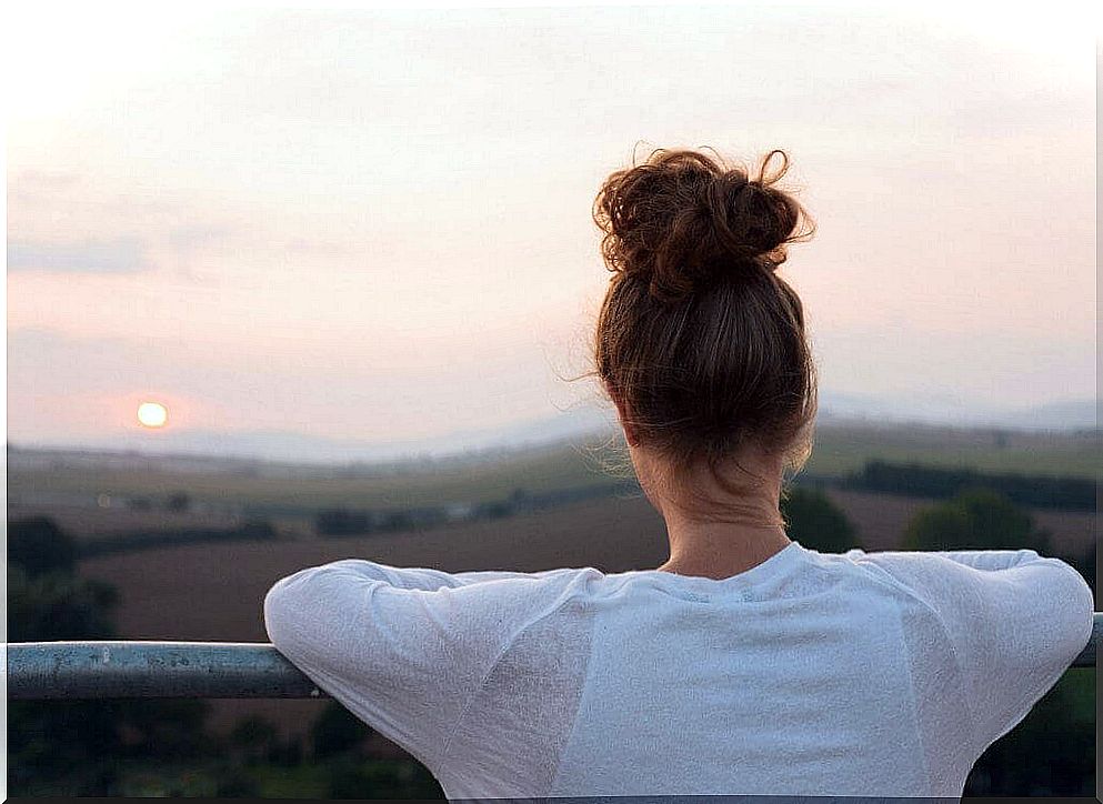 Woman is watching the sunset