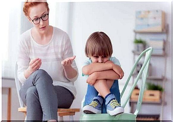 Disintegrative disorder - child huddled in a chair with a woman talking to