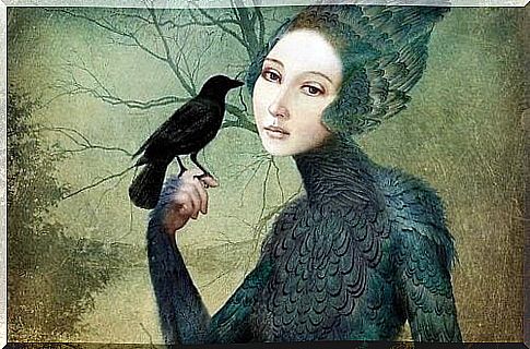 A woman holds a raven in her hand