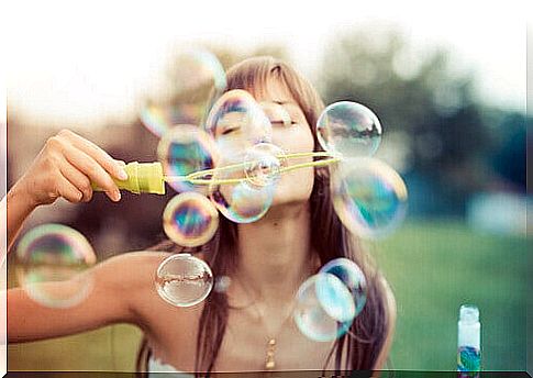 Woman makes soap bubbles