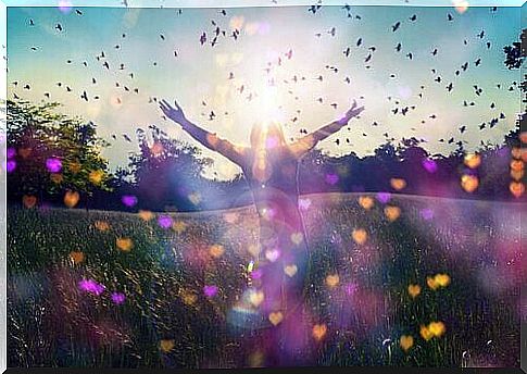 Woman stretches her hands to the sky