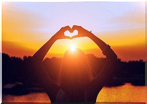 Woman forms a heart with her hands