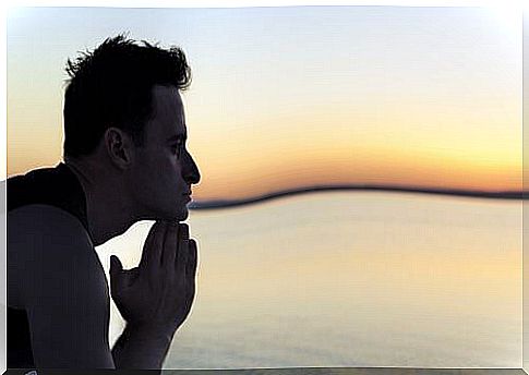 Thoughtful man looks out to sea