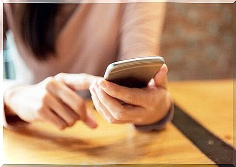 Woman is typing on cell phone