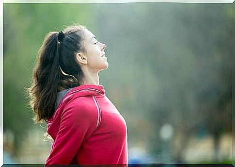 Woman taking deep breaths after exercising