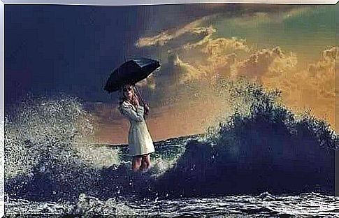 A woman with an umbrella walks across the ocean.