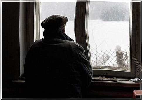 Man with Alzheimer's disease looks out the window