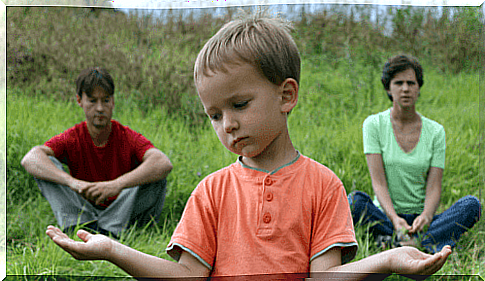 Child with parents in the background