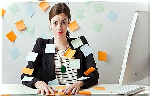 A woman is buried under post-its.