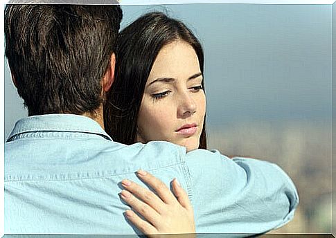 sad woman being hugged by a man