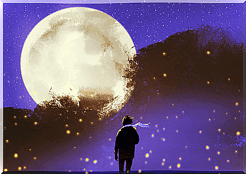 Boy with a scarf in front of a huge moon