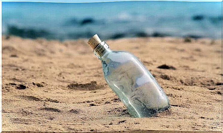 Glass bottle is stuck in the sand