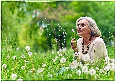 Elderly woman with dandelions