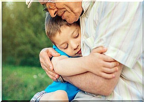 Across generations: a grandfather hugs his grandson.