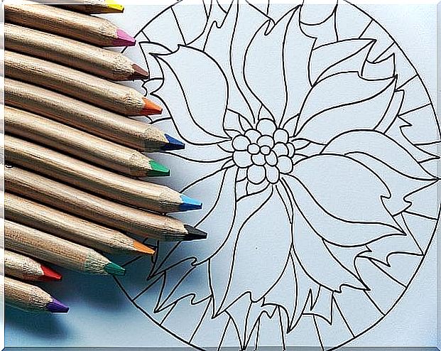 Mandala on which colored pencils lie