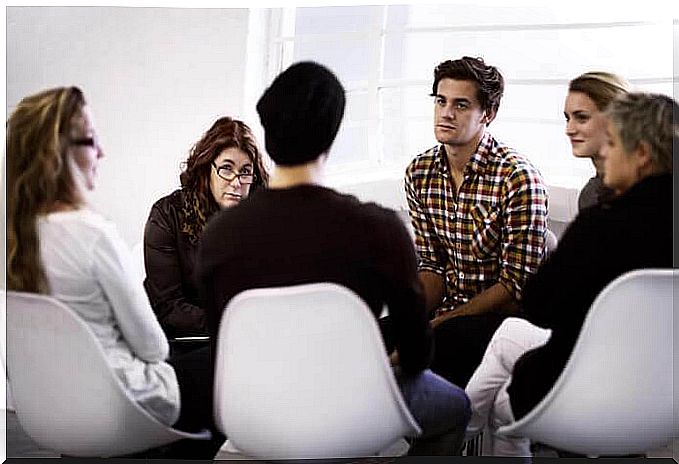 Self-help group sitting in a circle exchanges ideas.